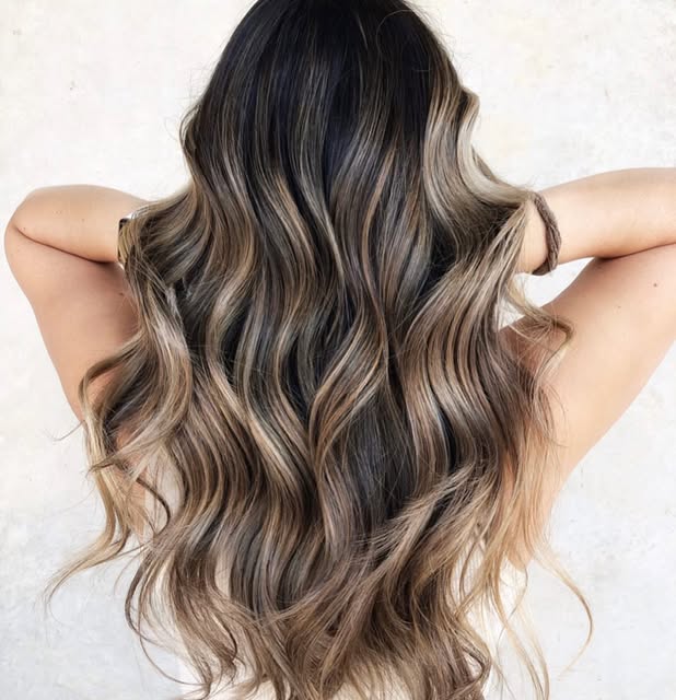 Long dark hair with soft caramel balayage waves